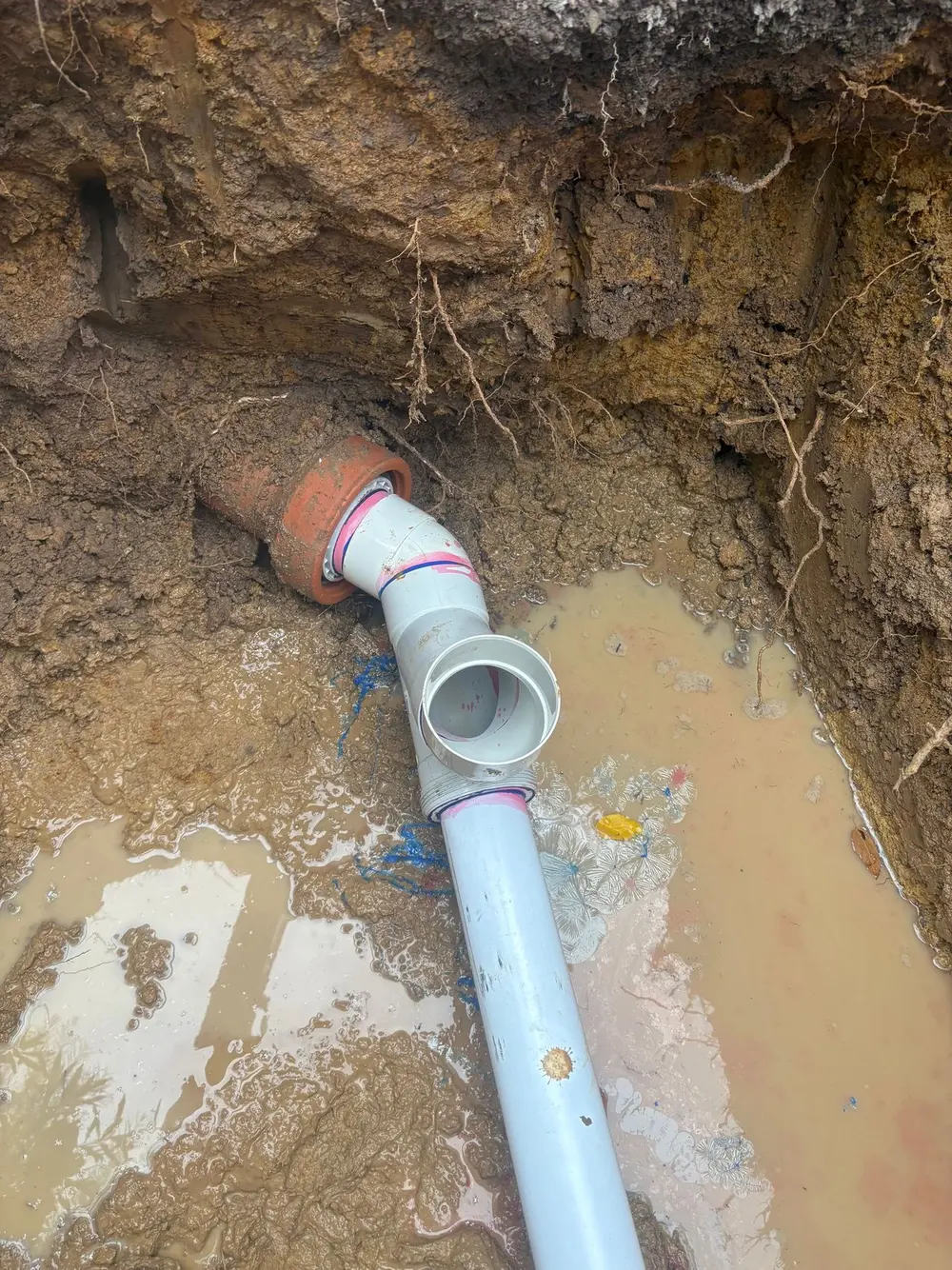 Underground drainage pipe installed in an excavated trench