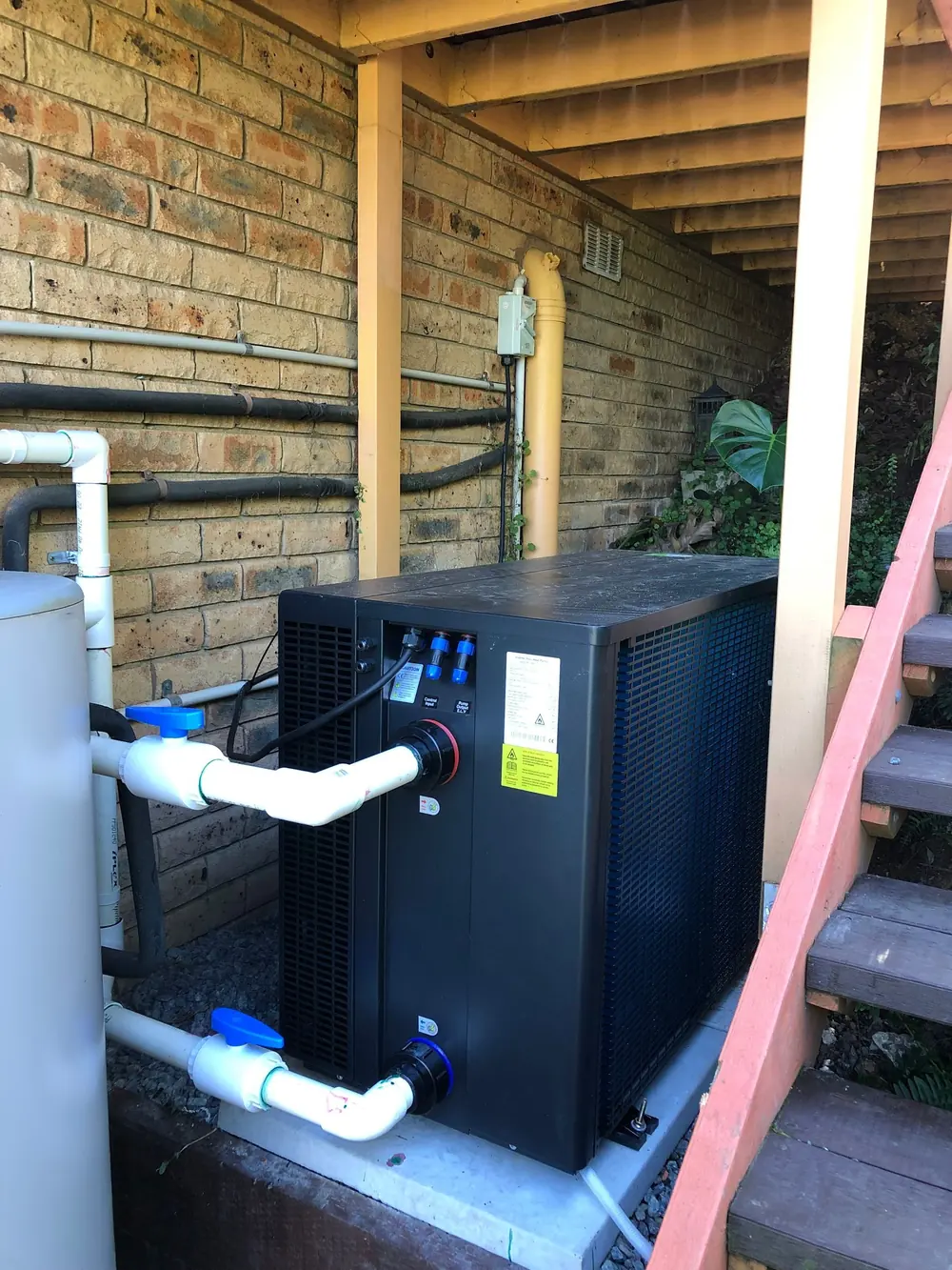 Heat pump hot water system installed beneath a raised deck